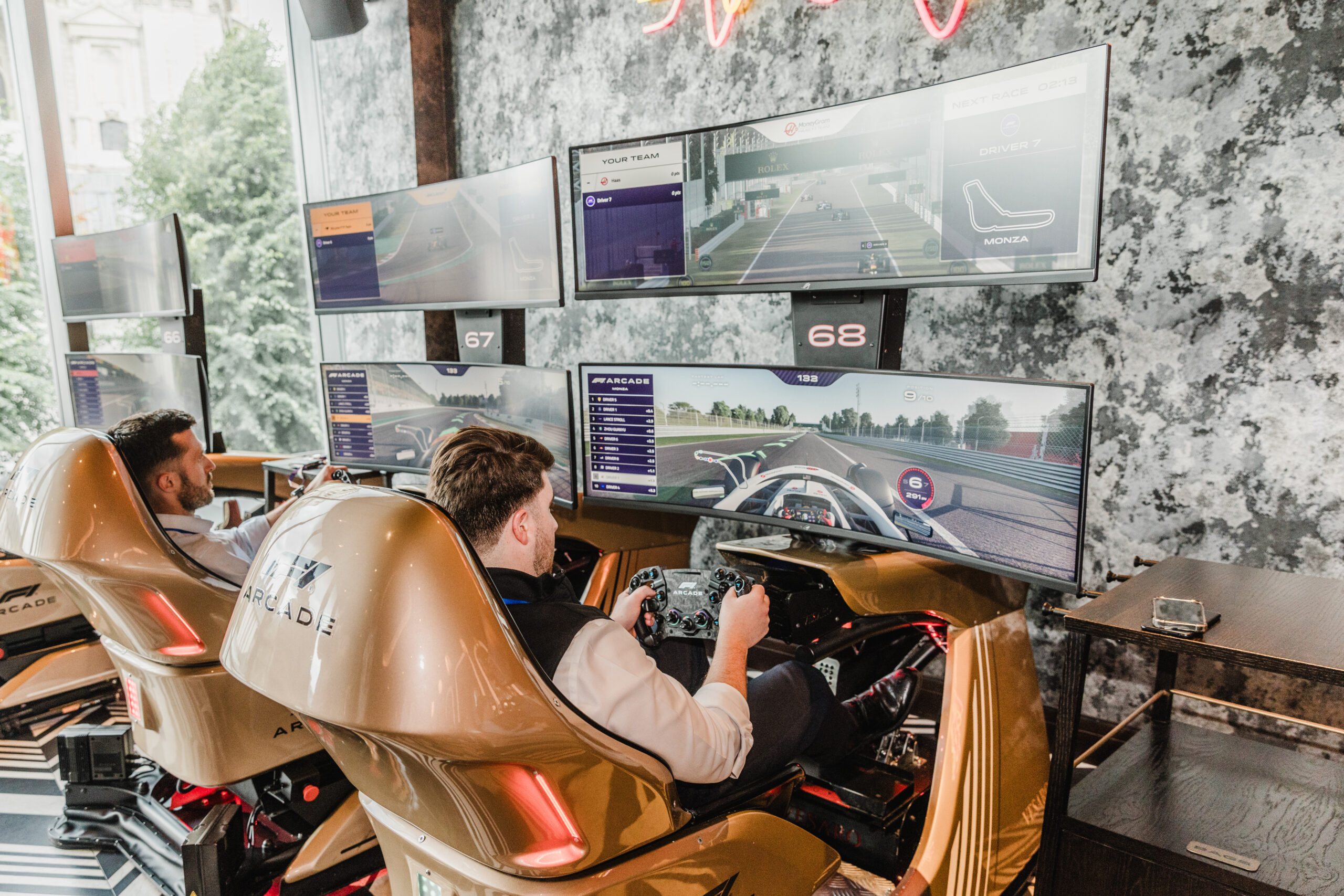 Payapps guests on the racing simulator at the F1 Arcade, London