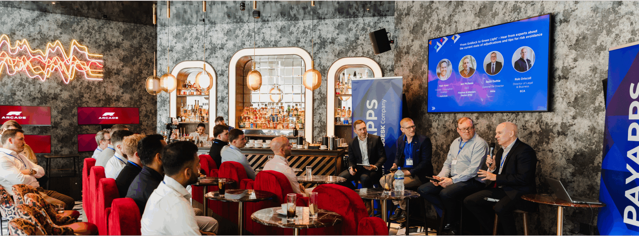 Panelists at the From Gridlock to Green Light Event at the F1 Arcade, London