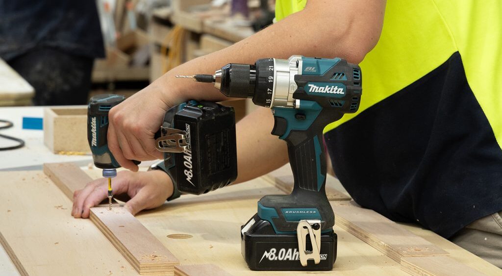 Unita worker using drill