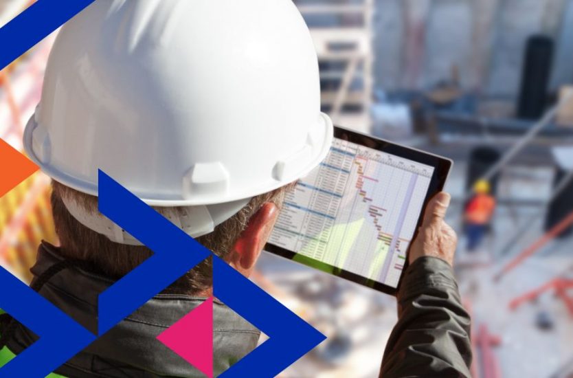 Construction worker reviewing productivity data on tablet